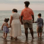 Family photos on the beach. Mixed race family.
